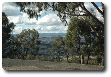 View over city and plains to distant hills