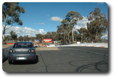 Mazda parked off side of race track