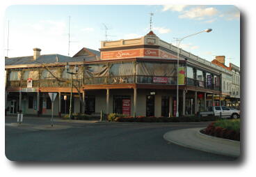 Two storey building with wooden verandah on top