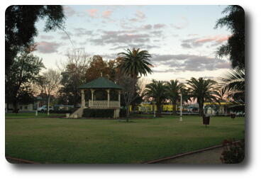 City park with palm trees and band rotunda