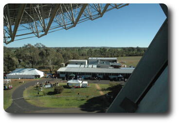 Low buildings seen between bottom of dish and telescope support