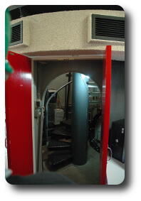 Open doors with spiral staircase behind