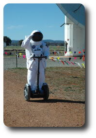 Actor in US space suit riding Segway near 12 metre telescope