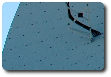 Close up of white metal dish showing black spots