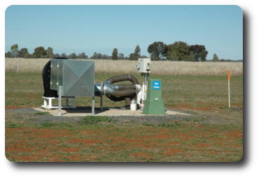 Pump with pipes to underground out in middle of field