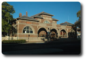 Brick building with semi-circular windows and arches on front