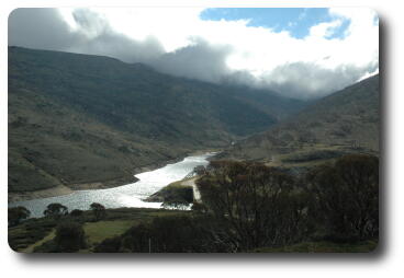 Dam, wall barely visible, sunlight reflecting off water