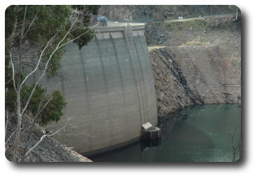 Upstream view of dam wall with nearly empty dam