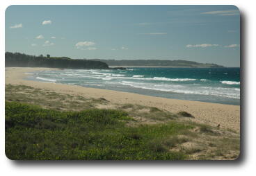 Beach scene with waves and distant headlands