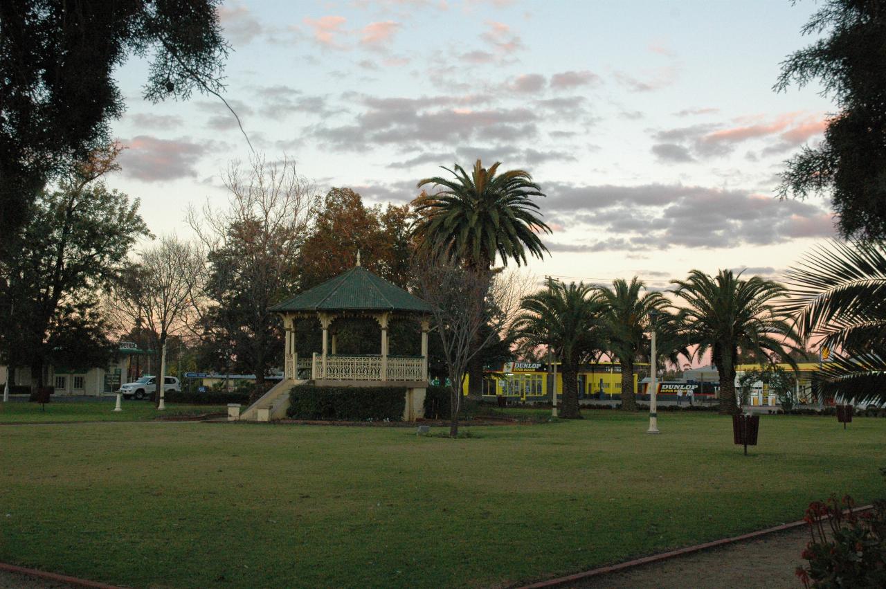 City park with palm trees and band rotunda