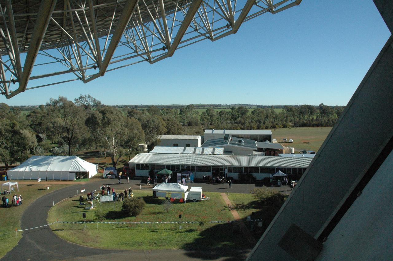 Low buildings seen between bottom of dish and telescope support