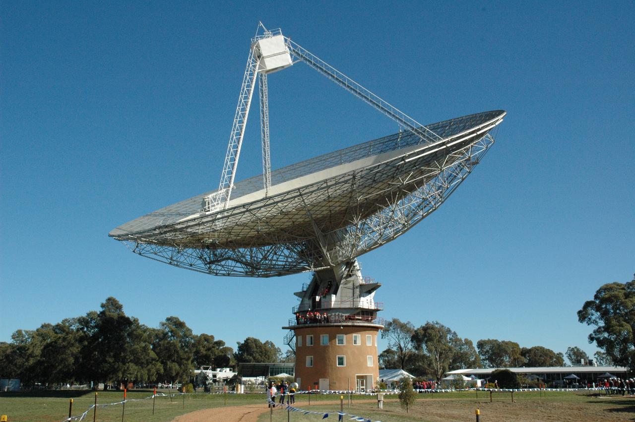 Telescope pointing up, with with box at top of tripod on top of dish