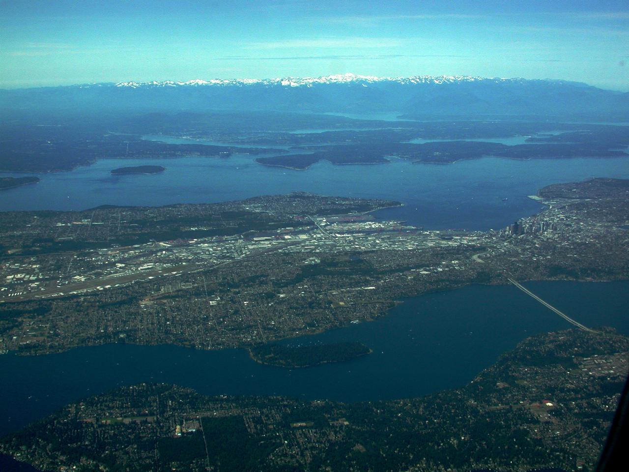 WIde angle view of land, water and distant mountains