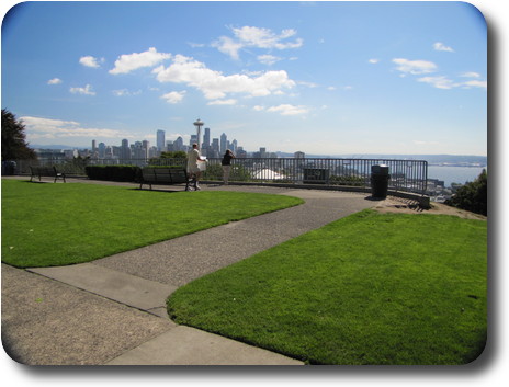 Grassy area with benches and view to downtown Seattle
