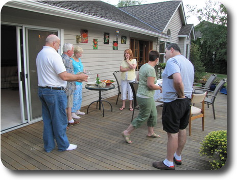 Six people standing around discussing cooking