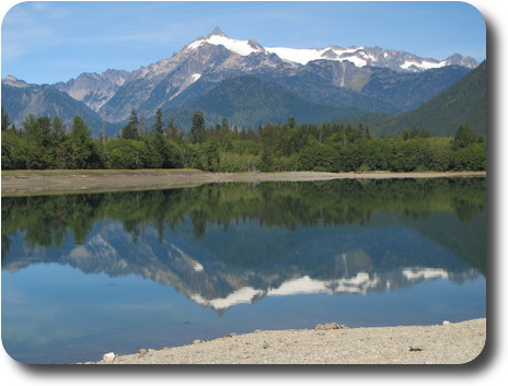 Craggy, snowy peak reflected in lake
