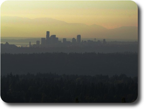 Several hills leading to Seattle skyline in the distance