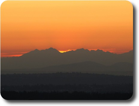 Last of bright sky behind distant mountains