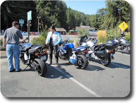 Three motorcycles and a man and a woman
