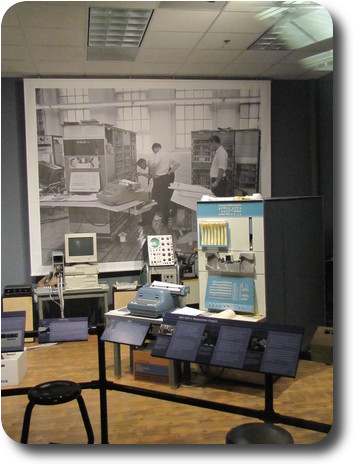Blue and white computer box in front of old photo of DEC building in New England