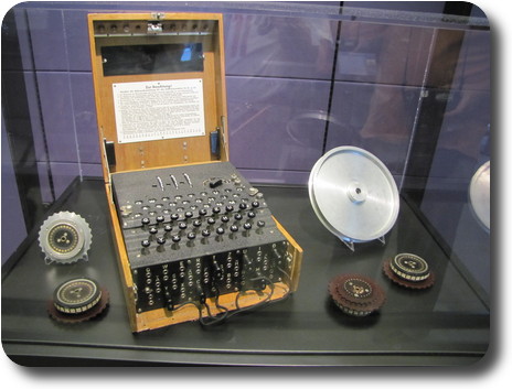 Wooden box with rotary switches, keyboard and plugs, and several pulleys