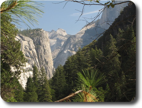 Looking over trees into valley with many sheer rock faces