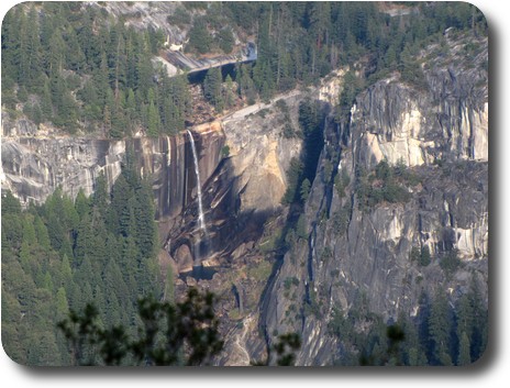 A shorter waterfall down a sheer cliff with a lake above and below