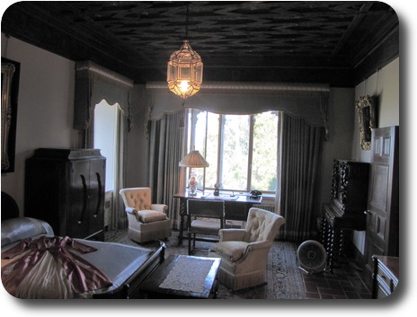 Smallish bedroom, still with bed, chairs and writing table