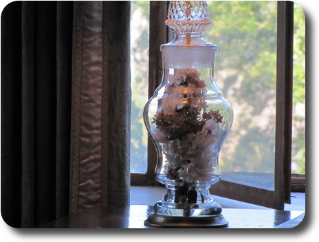 Base of lamp,  mostly clear glass with flowers (presumably not real) inside