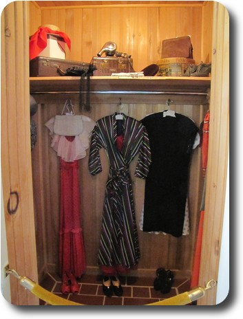 Closet with wood panelling and some clothing props