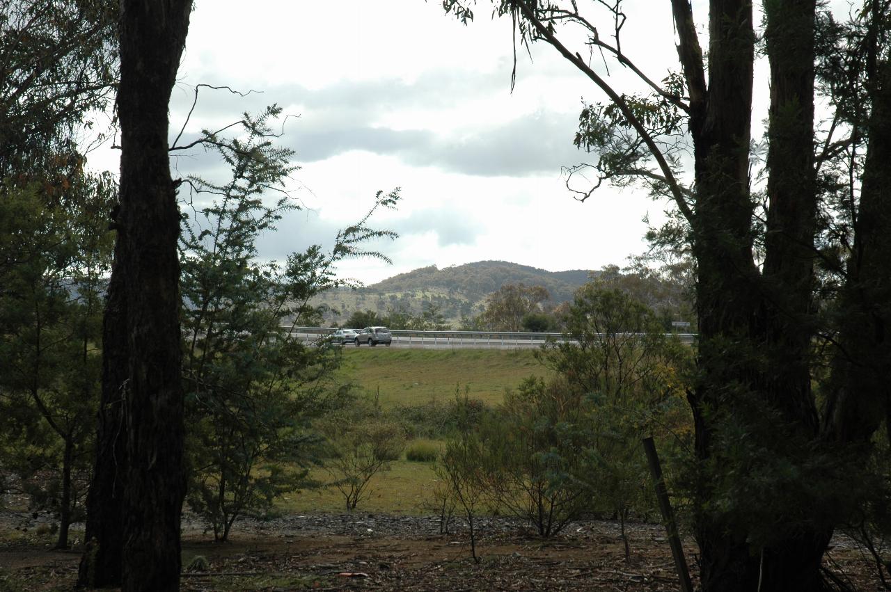 Grassy area to freeway, and hills beyond