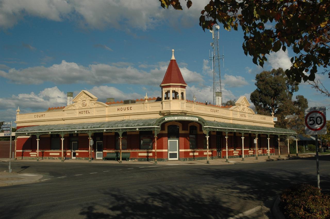 Corner building, single storey, turret on corner, awnings along the sides