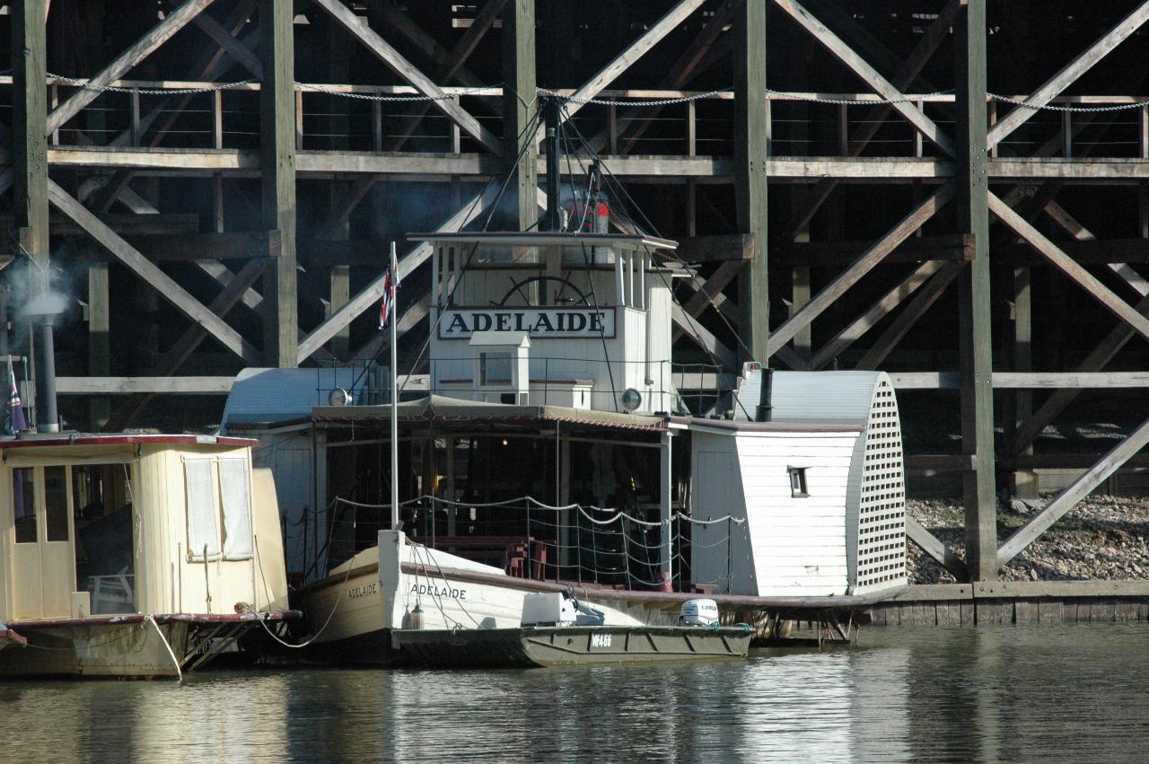 Paddle wheeler tied up to wharf, way below the top level