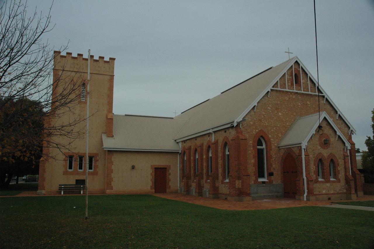 L shaped church of stone, with tower at short end of the L