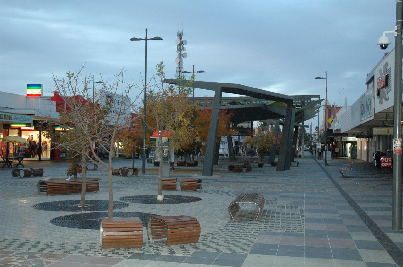 Street scene, tiled, street furniture and large awning in the middle