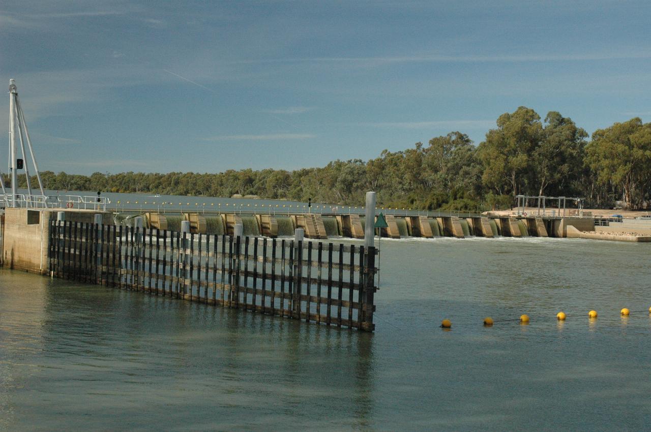 Small concrete weir, perhaps 4m high, crossing the river from the lock to the other bank.