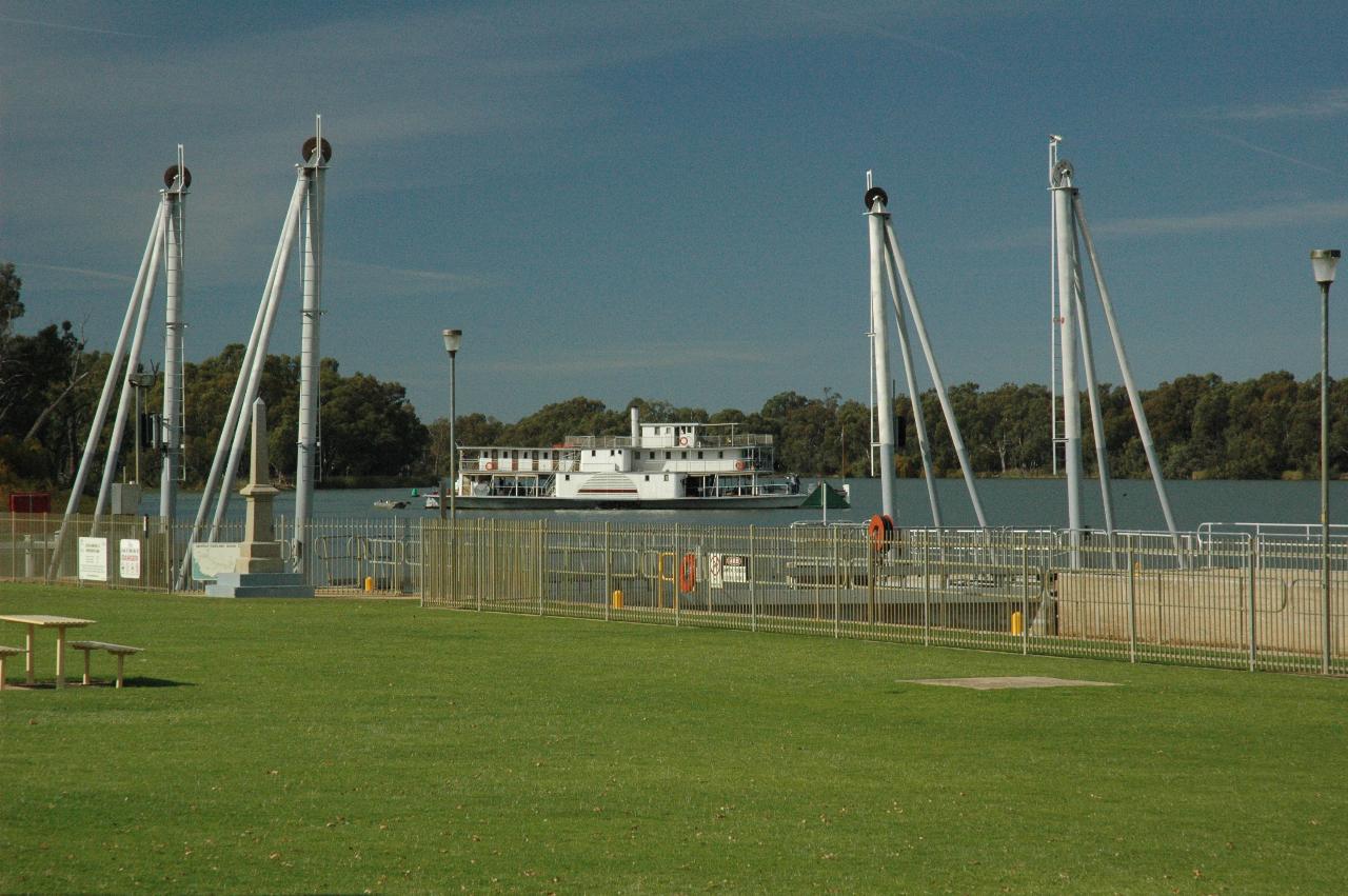 Upstream end of lock, in grassy area, with paddlewheeler turning in the river