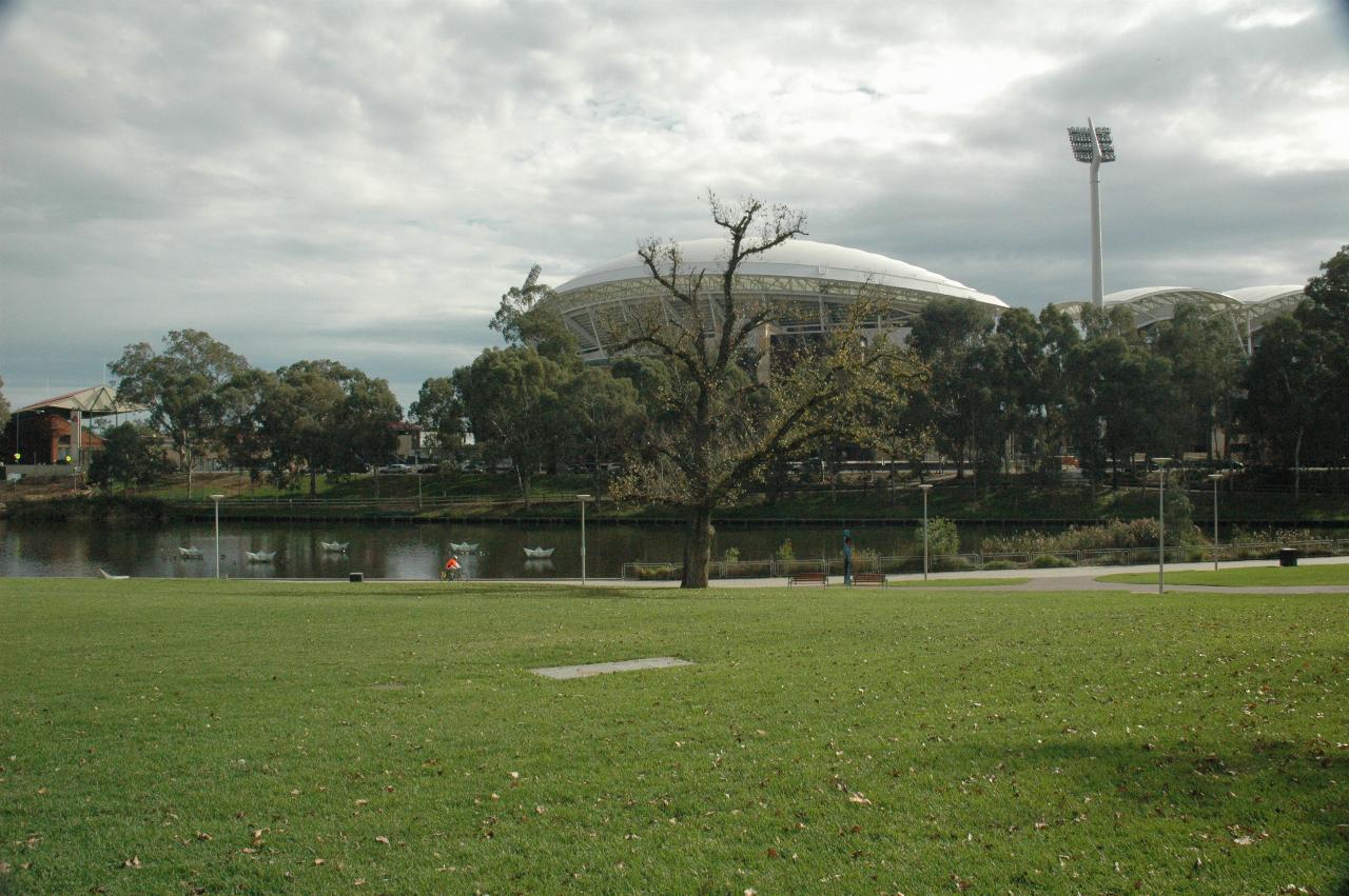 White domed looking building behind trees on the other side of river