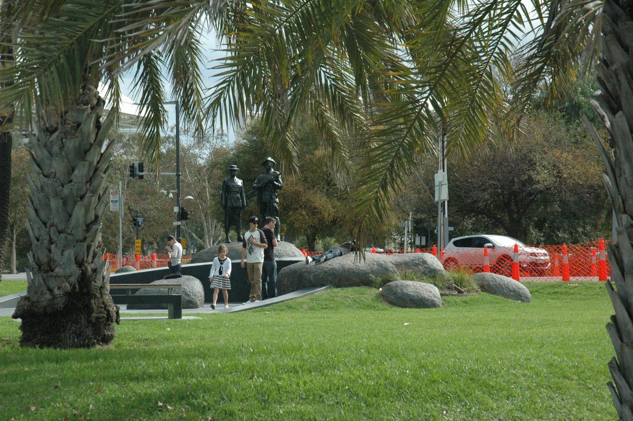 Bronze soldiers standing on rock in memorial setting