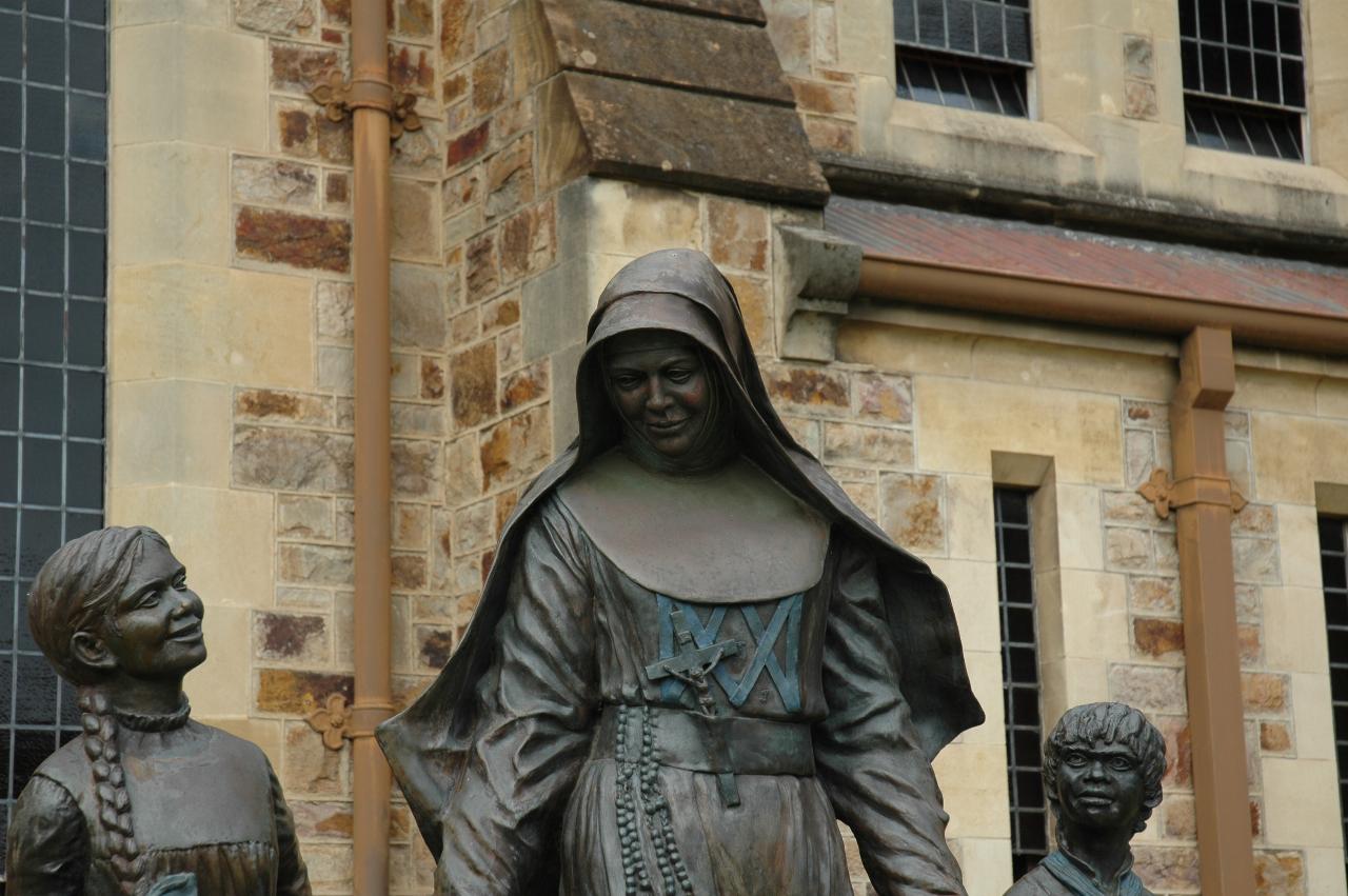 Head shot of nun with 2 children, at least one Aboriginal
