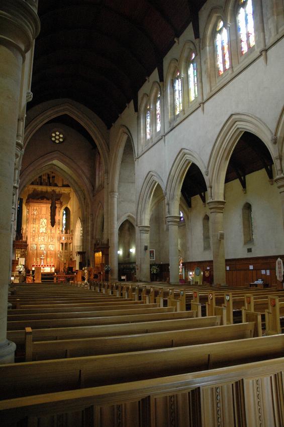 Looking down main aisle of church towards sanctuary, vaulted ceiling