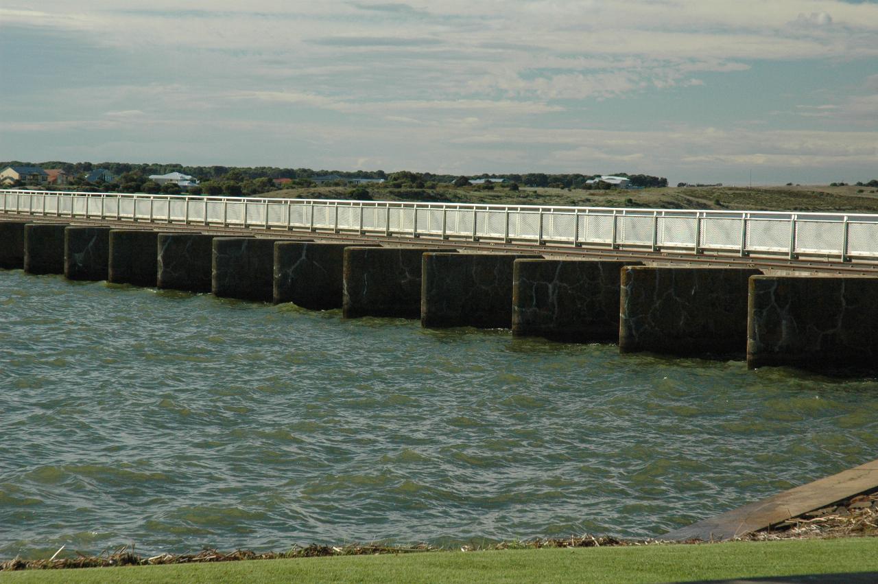 Small retaining/dam wall, with white railing along the top