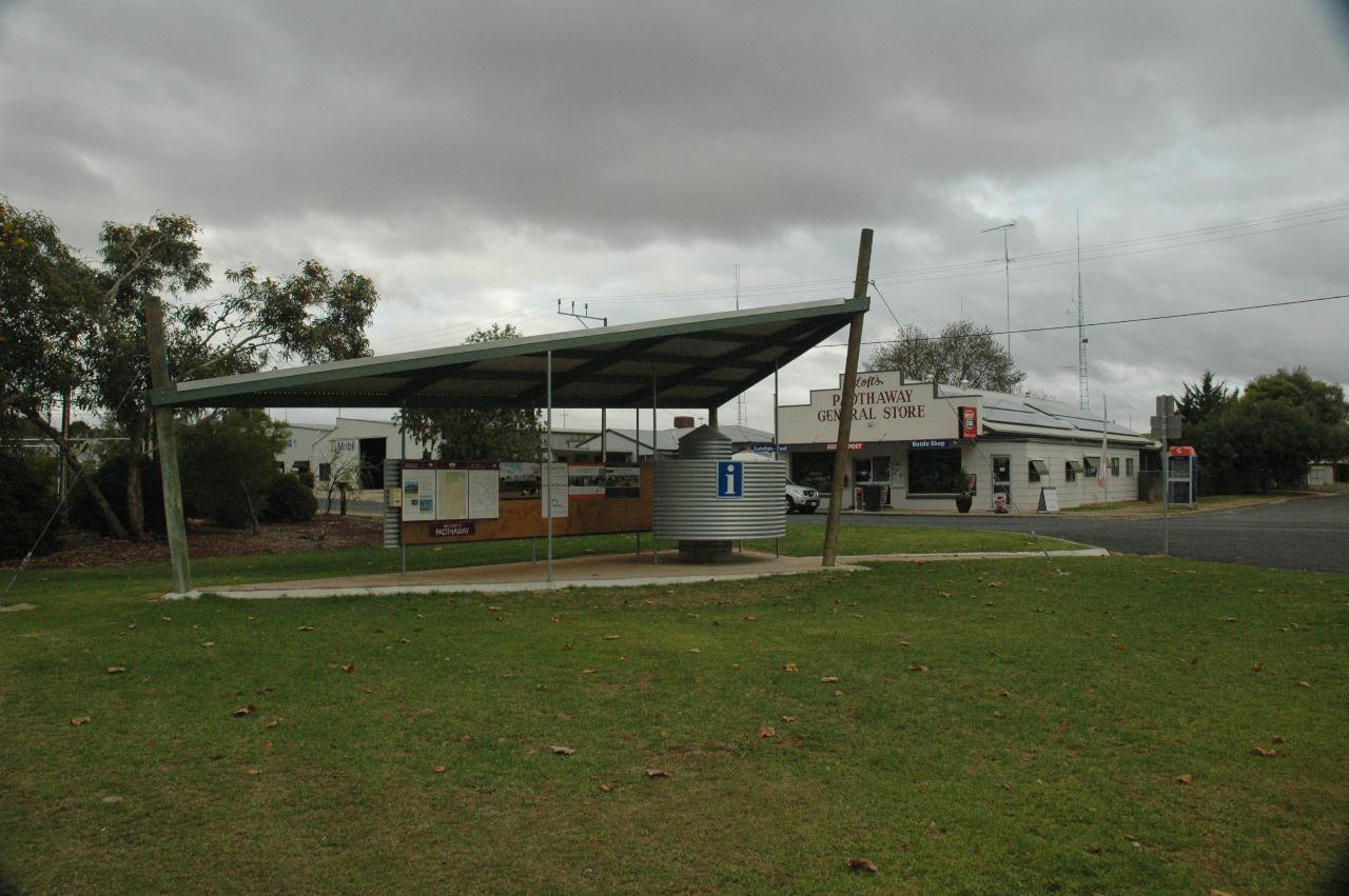 Triangular roof over tourist information, cream single storey building behind, with solar panels on roof