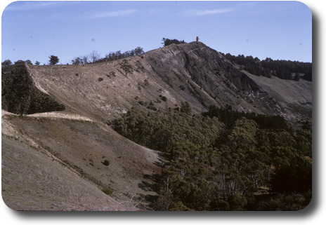 Stone tower sitting atop a barren hillside