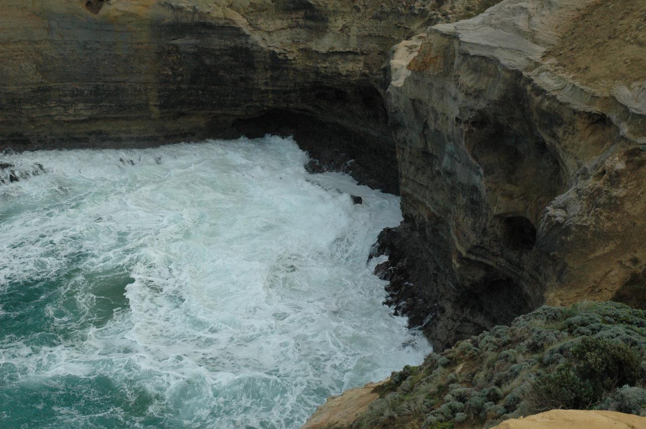 White water at base of cliff in small inlet which shows erosion at base