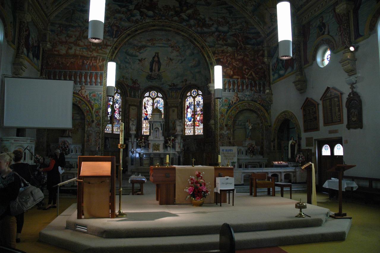 Front of church, including new and old altars, stained glass windows and mural