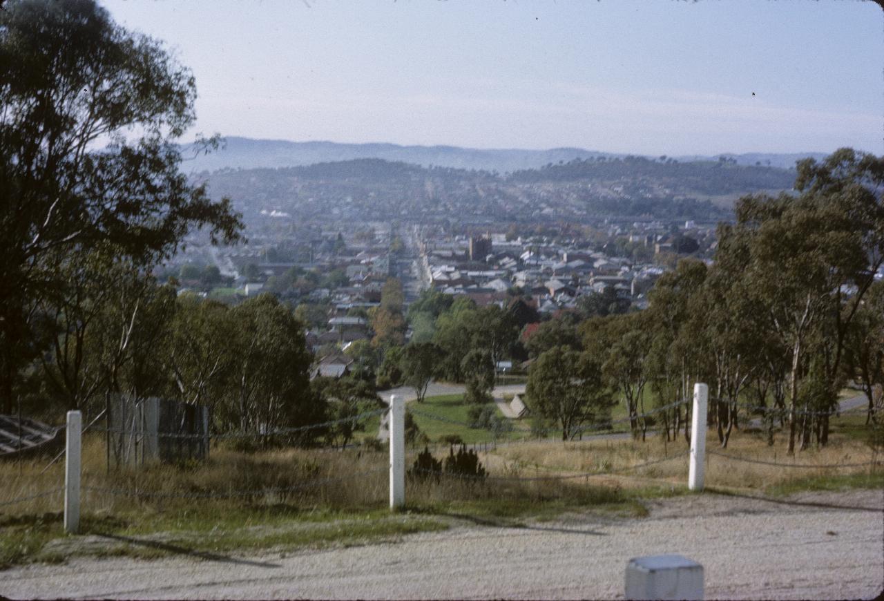 View from hill over city and on to nearby hills
