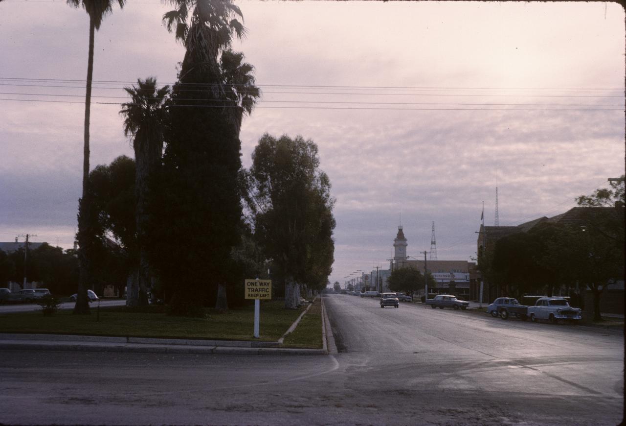 Very wide divided street with wide divider featuring large trees