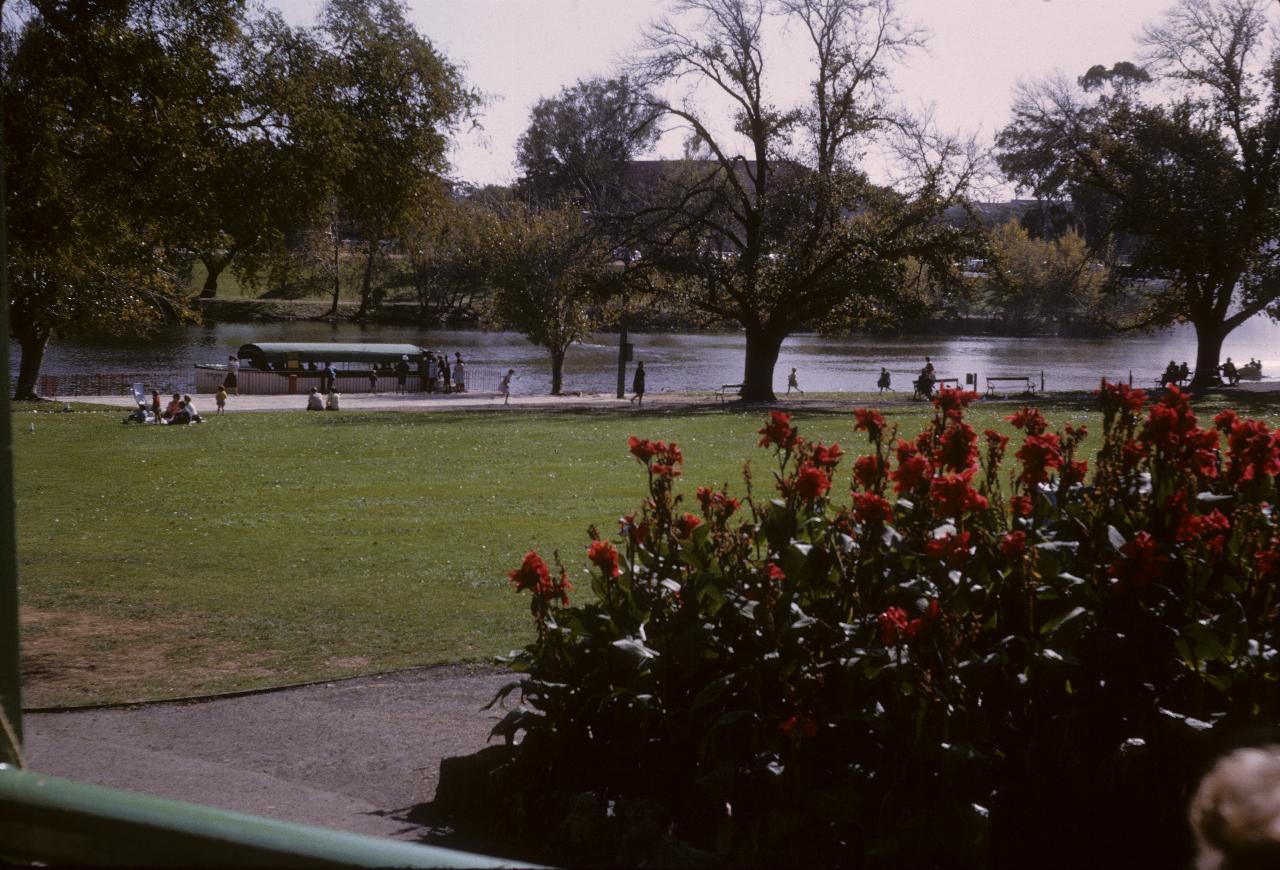 View of tour boat on river seen from a park