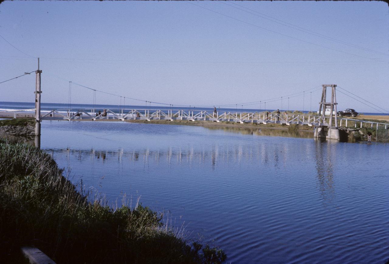 Pedestrian suspension bridge across river mouth